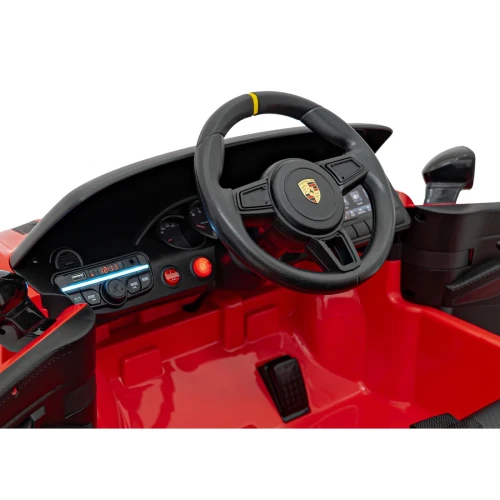 Kokpit z kierownicą, panelem audio i ekranem dotykowym – wnętrze czerwonego Porsche Spyder RS 718 na akumulator dla dzieci.webp
