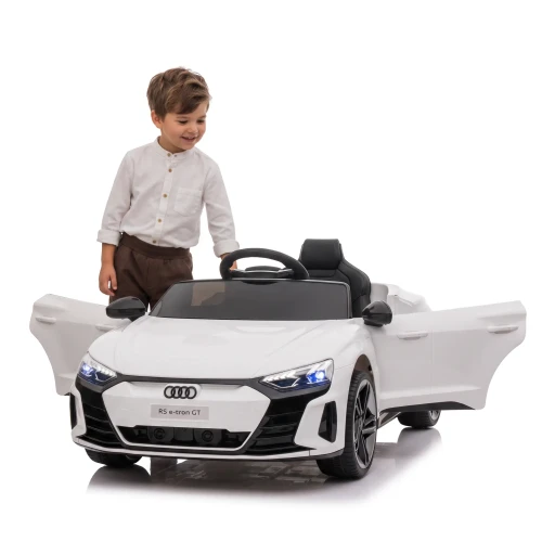 Białe Audi RS E-tron z chłopcem ktory stoi obok pojazdu - merikids.webp
