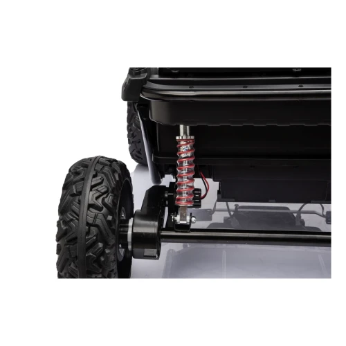 Tylny amortyzator sprężynowy i silnik przy kole – zbliżenie zawieszenia różowego buggy Sport Outland 4x4 na akumulator dla dzieci.webp