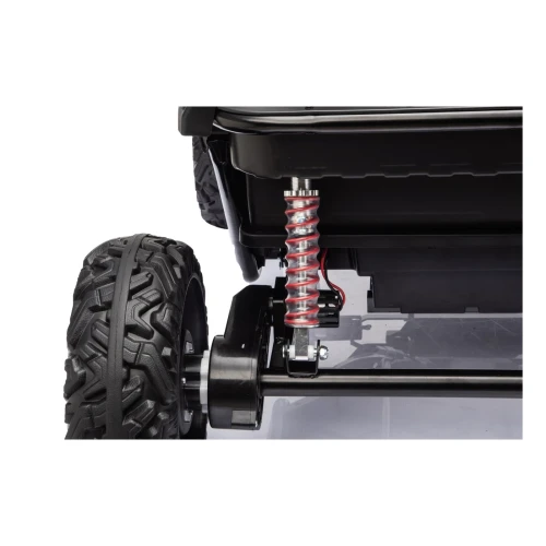 Tylny amortyzator sprężynowy i silnik przy kole – zbliżenie zawieszenia niebieskiego buggy Sport Outland 4x4 na akumulator dla dzieci.webp