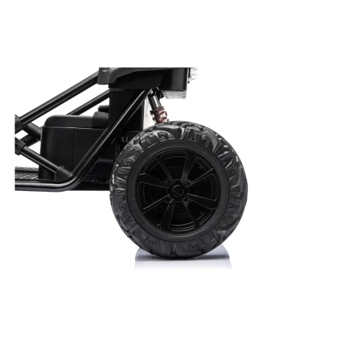 Tylne koło EVA z czarną felgą i amortyzatorem – zbliżenie czerwonego buggy Sport Outland 4x4, pojazd elektryczny dla dzieci.webp